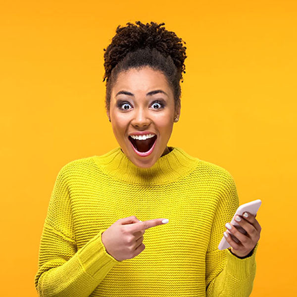 Happy, surprised lady with phone in hand