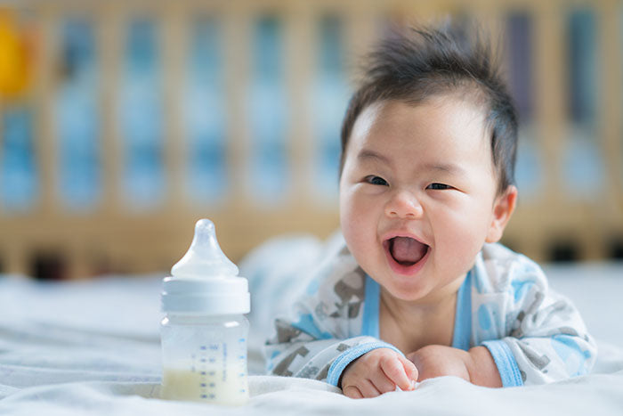 image of baby with bottle